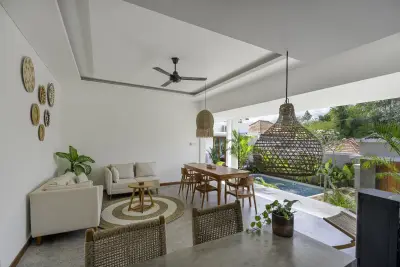 Open-air shared living and dining area overlooking the pool